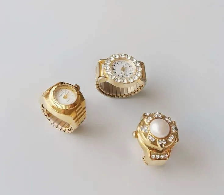 Gold ring watches with crystals and pearl